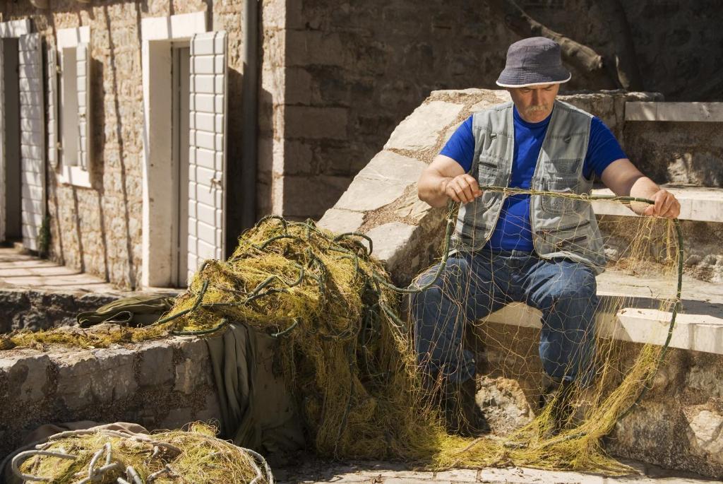 Fisherman fixing nets in Petrovac (Montenegro Tourist Office)